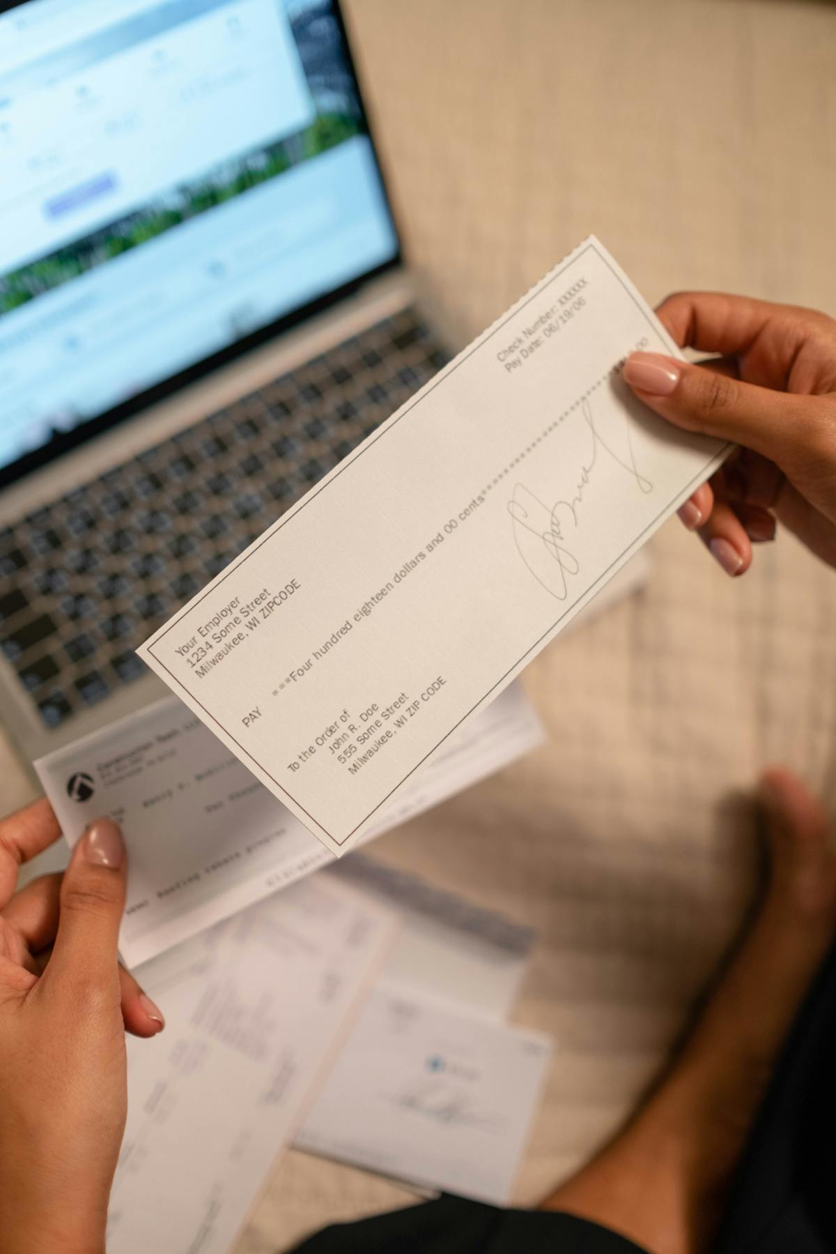Person holding a cheque for bank deposit processing